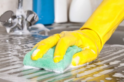Domestic cleaner preparing a tidy Islington flat for a regular home clean